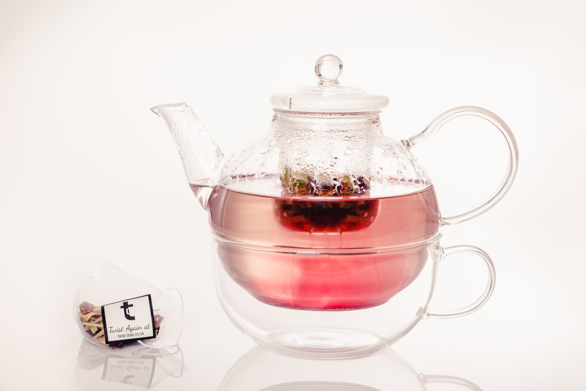 A glass teapot and cup of Twist tea