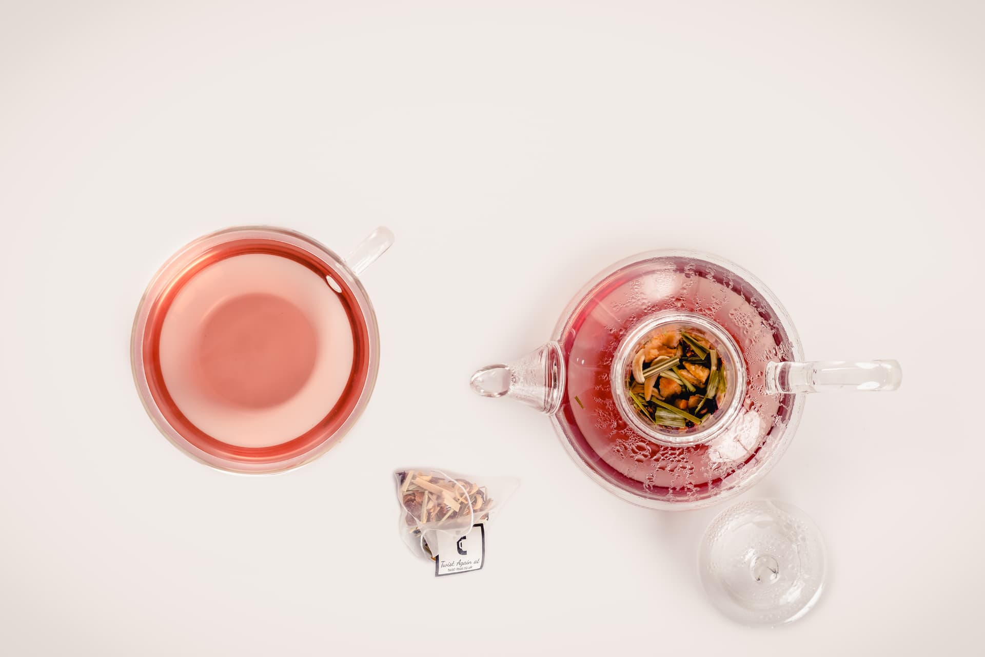 A glass teapot and cup of Twist tea from above