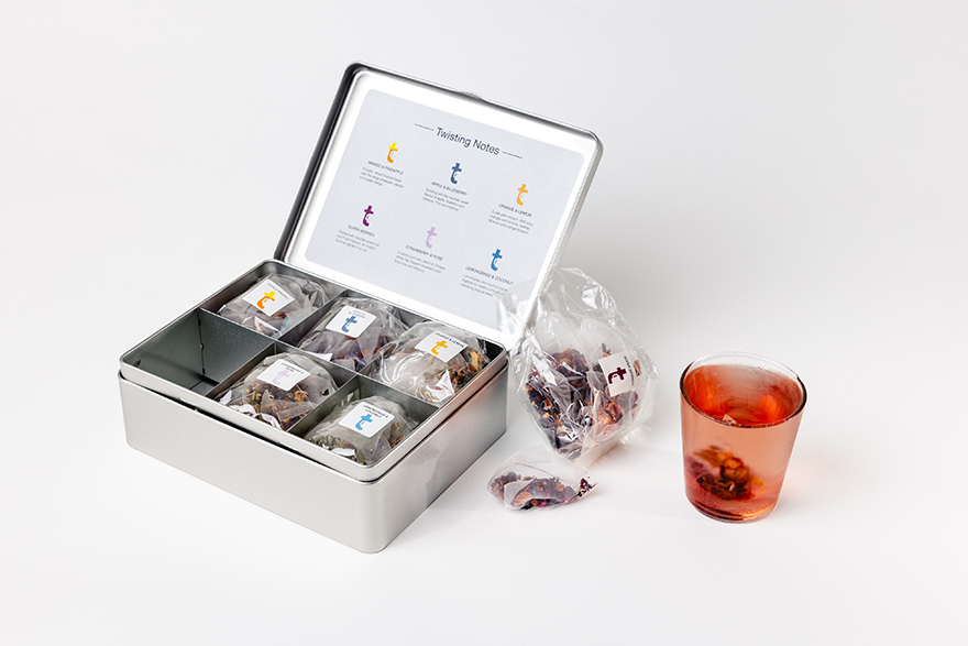 Cold tea over ice beside the Cold Brews tasting menu caddy