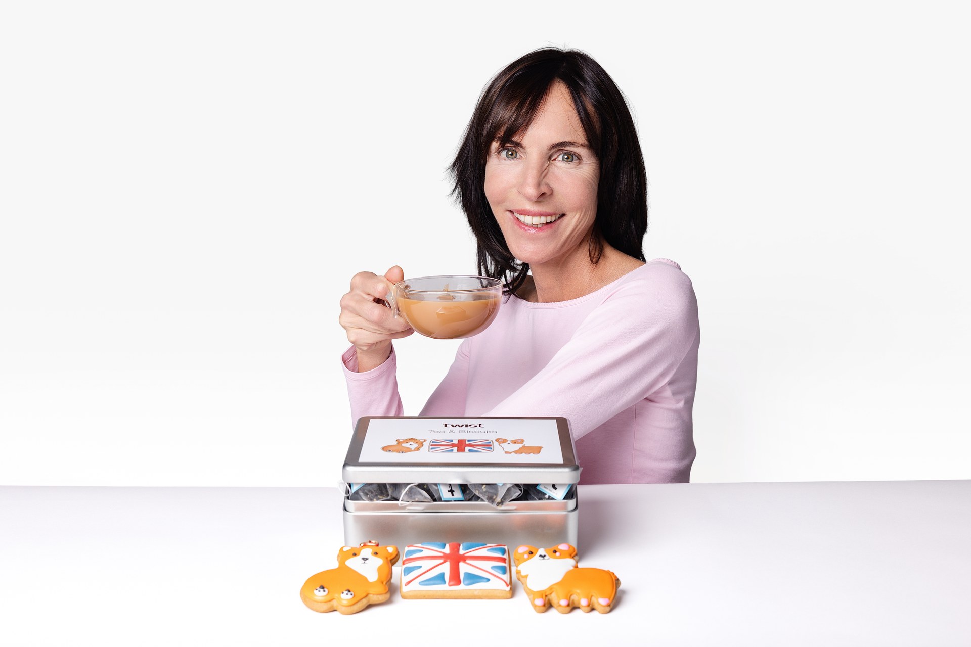 Claire with a cup of tea and the Twist Tea and Biscuits Caddy