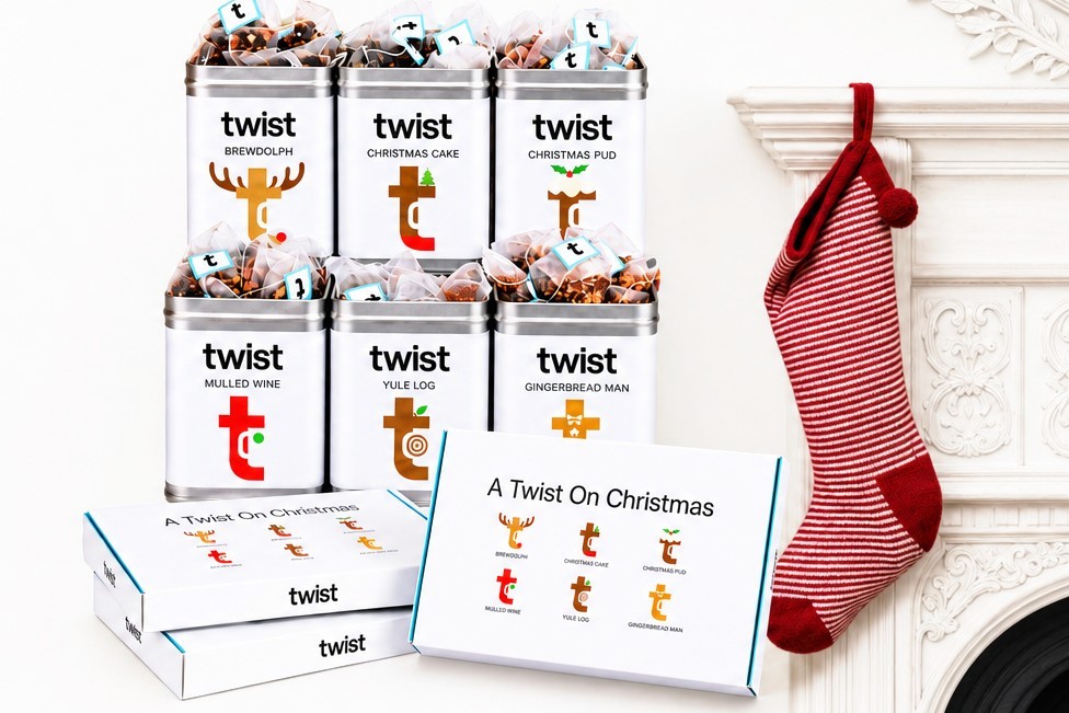 Twist Christmas tea caddies and A Twist On Christmas tasting menus by a white mantelpiece with a red stocking