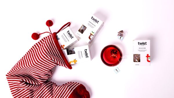 Christmas Tea Cartons: cartons spilling from a stocking Christmas tea cartons spilling from a striped stocking beside a cup of Mulled Wine
