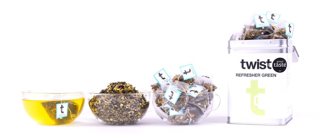 Twist Green Tea: a cup of tea, the loose leaf and the caddy