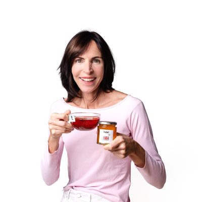 Claire from Twist Teas with a cup of tea and a jar of Pollards Farm honey